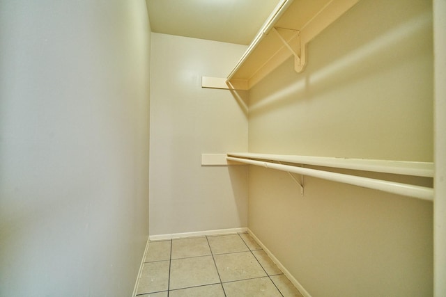 14835 Delbarton Dr, Houston, TX 77083 - walk in closet with light tile patterned flooring