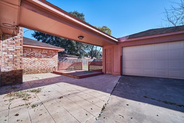 14835 Delbarton Dr, Houston, TX 77083 - view of patio featuring asphalt driveway and an attached garage