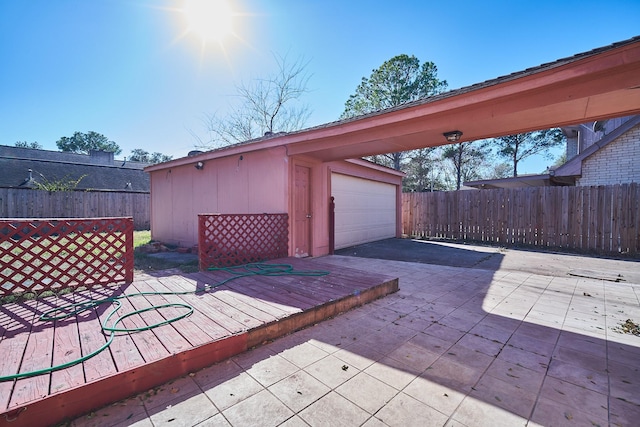 14835 Delbarton Dr, Houston, TX 77083 - wooden deck featuring an outbuilding, a garage, and asphalt driveway
