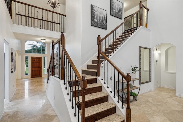 14610 Majestic Oaks, Magnolia, TX 77354 - foyer entrance featuring a towering ceiling, arched walkways, marble tiled flooring, and stairs