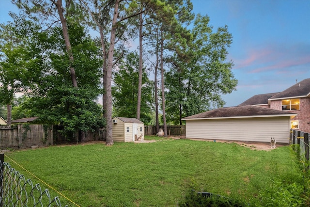 14610 Majestic Oaks, Magnolia, TX 77354 - yard at dusk featuring a storage unit and a fenced backyard