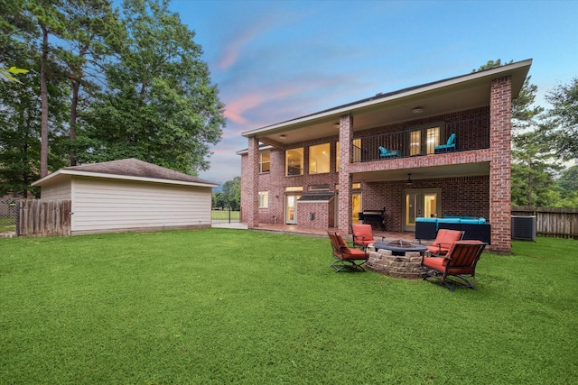 14610 Majestic Oaks, Magnolia, TX 77354 - back of house with a fire pit, a balcony, and brick siding