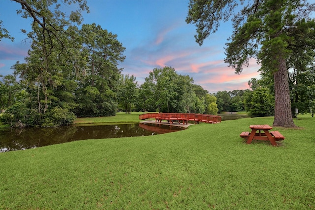 14610 Majestic Oaks, Magnolia, TX 77354 - yard at dusk with a water view and a yard