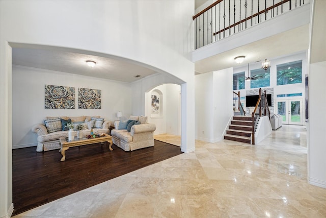 14610 Majestic Oaks, Magnolia, TX 77354 - living room featuring arched walkways, a towering ceiling, ceiling fan, marble tiled floors, and stairway