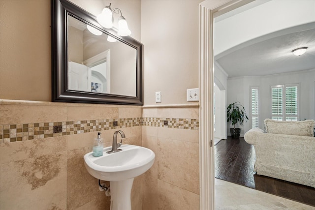 14610 Majestic Oaks, Magnolia, TX 77354 - bathroom with tile walls, wainscoting, ornamental molding, and wood finished floors