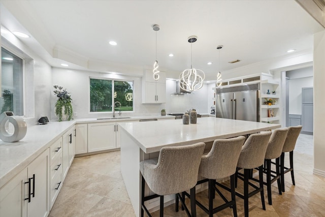 14610 Majestic Oaks, Magnolia, TX 77354 - kitchen with built in fridge, recessed lighting, white cabinets, a breakfast bar, and a kitchen island