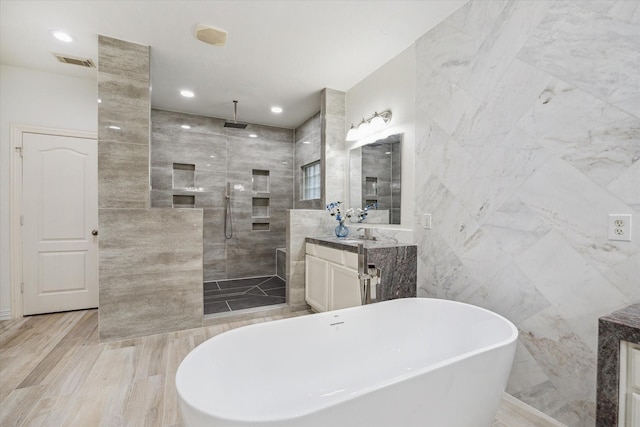 14610 Majestic Oaks, Magnolia, TX 77354 - full bathroom featuring tile walls, vanity, a walk in shower, a soaking tub, and recessed lighting