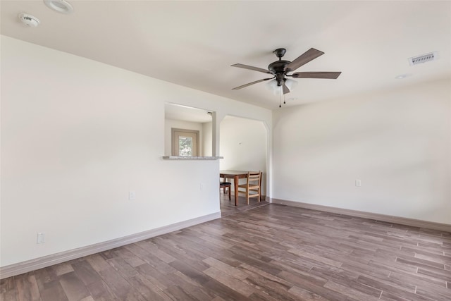 1407 Craig Dr, Galena Park, TX 77547 - unfurnished room with a smoke detector, wood finished floors, ceiling fan, and arched walkways