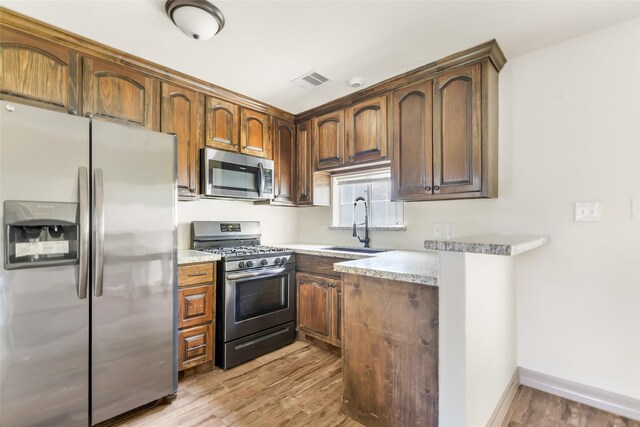 1407 Craig Dr, Galena Park, TX 77547 - kitchen with stainless steel appliances, light wood-style floors, and light countertops