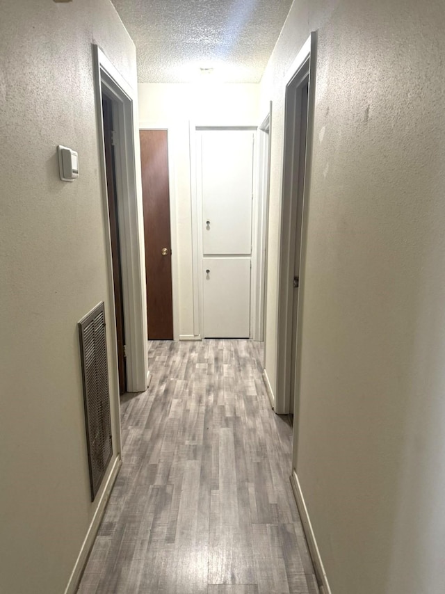 1722 Briar Ln, Wharton, TX 77488 - corridor featuring wood finished floors and a textured ceiling