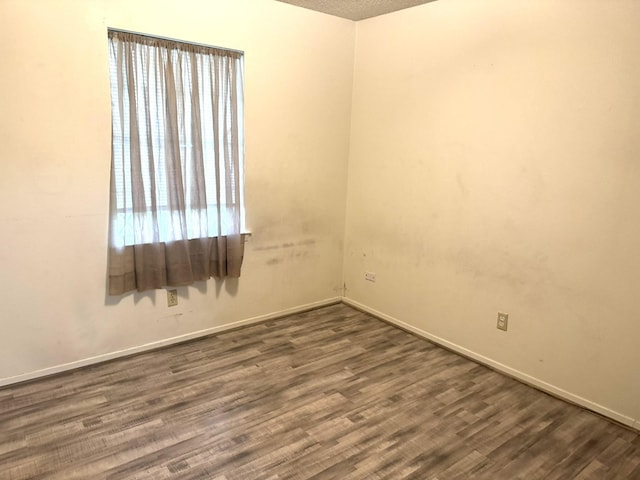 1722 Briar Ln, Wharton, TX 77488 - empty room with dark wood-style flooring and baseboards