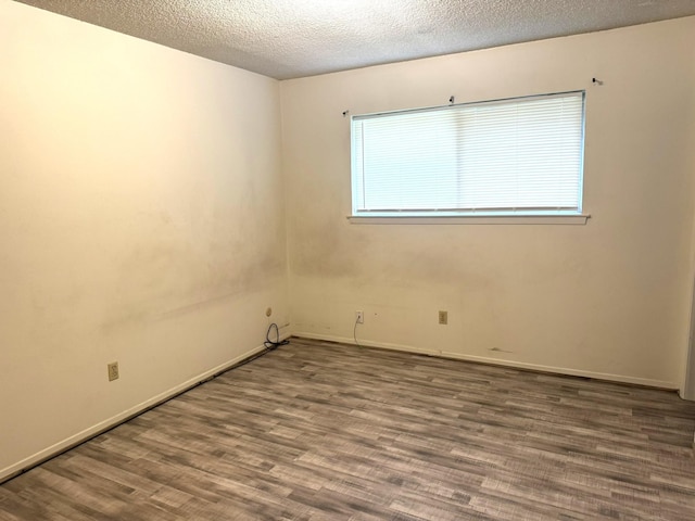 1722 Briar Ln, Wharton, TX 77488 - unfurnished room featuring wood finished floors and a textured ceiling