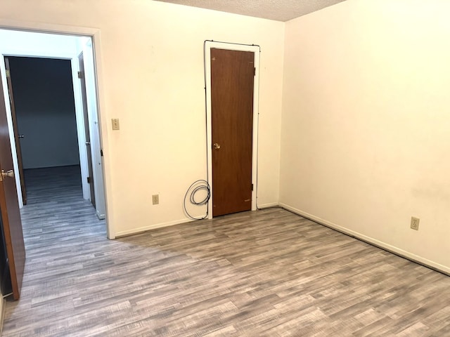1722 Briar Ln, Wharton, TX 77488 - unfurnished room featuring wood finished floors and a textured ceiling