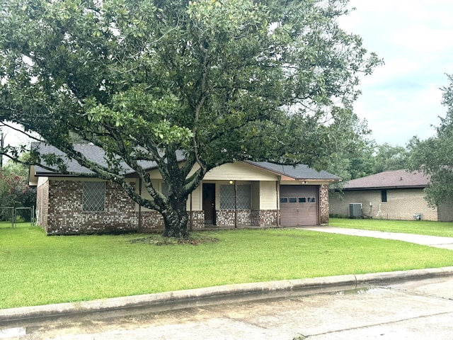 1722 Briar Ln, Wharton, TX 77488 - view of front facade with concrete driveway, a garage, brick siding, and a front lawn