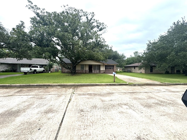 1722 Briar Ln, Wharton, TX 77488 - ranch-style home featuring concrete driveway, a garage, and a front yard