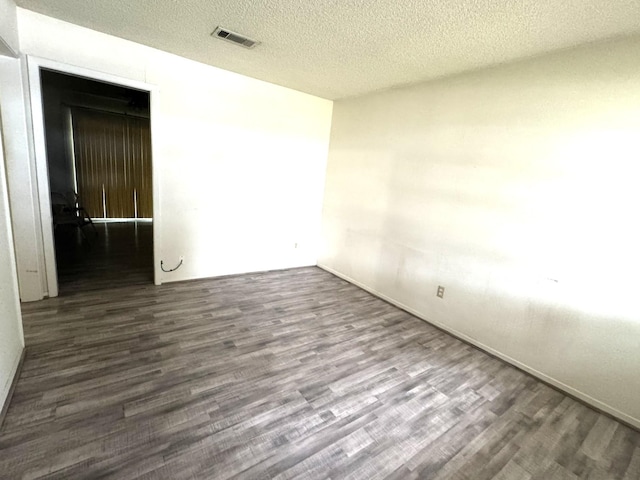 1722 Briar Ln, Wharton, TX 77488 - empty room with wood finished floors and a textured ceiling