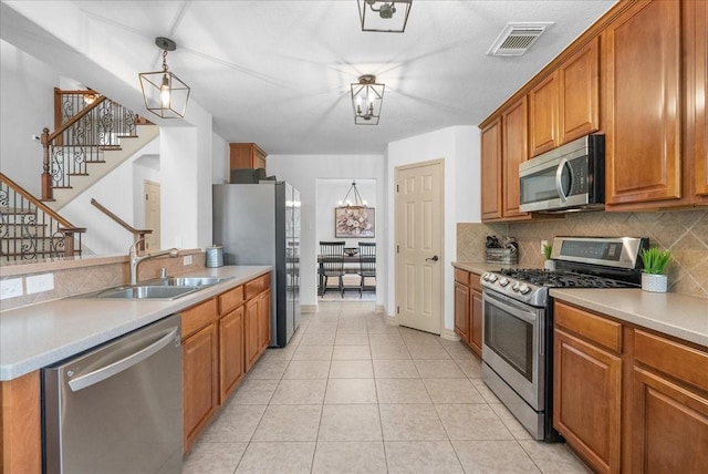 6907 Autumn Rain Ln, Spring, TX 77379 - kitchen with stainless steel appliances, backsplash, brown cabinetry, and light countertops