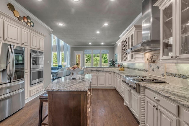 5434 Lockwood Bend Ln, Sugar Land, TX 77479 - kitchen with stainless steel appliances, wall chimney exhaust hood, ornamental molding, dark wood-style floors, and recessed lighting