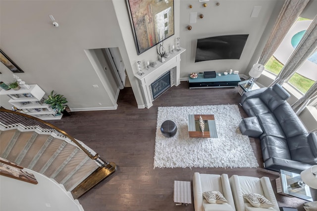 5434 Lockwood Bend Ln, Sugar Land, TX 77479 - living area featuring wood finished floors and a glass covered fireplace