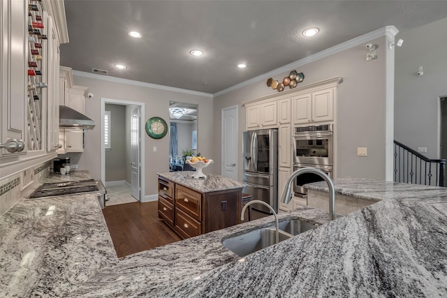 5434 Lockwood Bend Ln, Sugar Land, TX 77479 - kitchen featuring stainless steel appliances, range hood, light stone counters, ornamental molding, and recessed lighting
