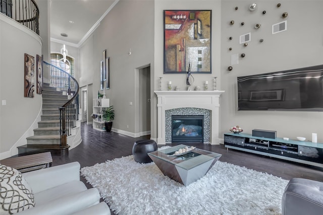 5434 Lockwood Bend Ln, Sugar Land, TX 77479 - living room with a high ceiling, wood finished floors, ornamental molding, stairs, and a fireplace