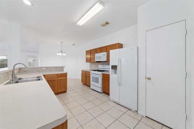 20126 Cypresswood Gln, Spring, TX 77373 - kitchen featuring white appliances, tasteful backsplash, a chandelier, light countertops, and light tile patterned floors