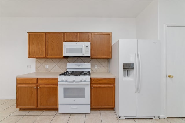 20126 Cypresswood Gln, Spring, TX 77373 - kitchen featuring white appliances, light countertops, backsplash, and light tile patterned floors