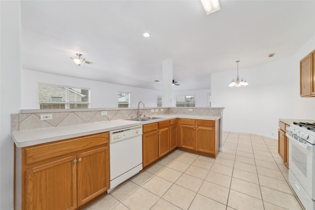 20126 Cypresswood Gln, Spring, TX 77373 - kitchen featuring white appliances, light countertops, a chandelier, decorative backsplash, and light tile patterned flooring