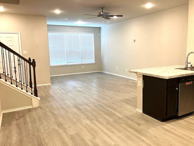 15806 Perthshire Creek Dr, Humble, TX 77346 - kitchen with stainless steel dishwasher, light countertops, ceiling fan, light wood-type flooring, and open floor plan