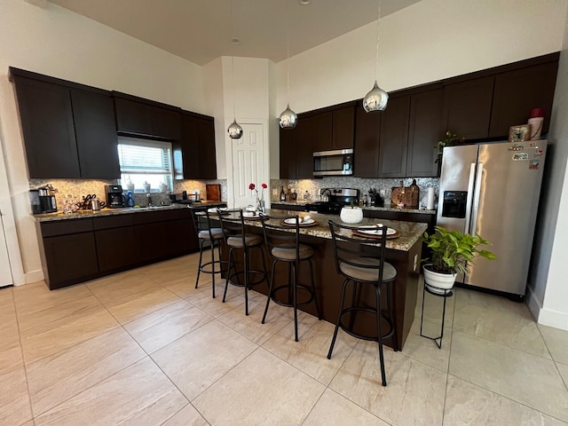 9737 Fabiola Dr, Houston, TX 77075 - kitchen featuring stainless steel appliances, a breakfast bar area, backsplash, and a high ceiling
