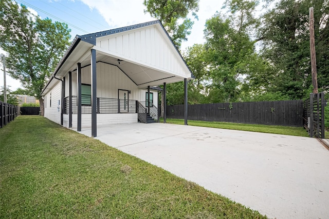 2015 Creston Dr, Houston, TX 77026 - view of side of property featuring concrete driveway, a carport, and board and batten siding
