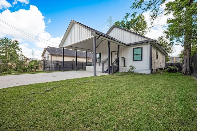 2015 Creston Dr, Houston, TX 77026 - view of front of house featuring concrete driveway, board and batten siding, and a carport