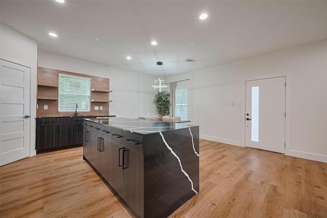 2015 Creston Dr, Houston, TX 77026 - kitchen featuring open shelves, recessed lighting, modern cabinets, light wood-style floors, and a center island