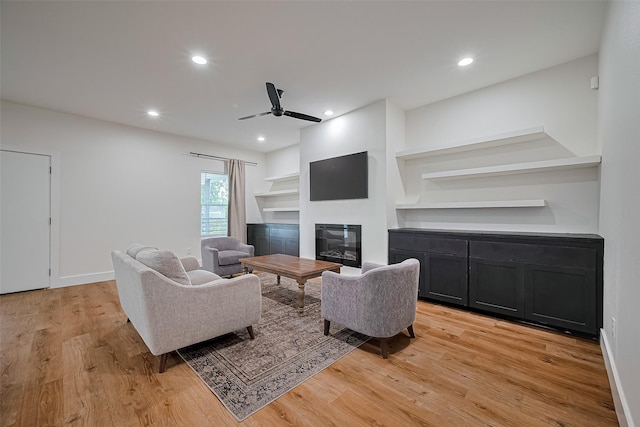 2015 Creston Dr, Houston, TX 77026 - living room featuring ceiling fan, light wood-style flooring, a glass covered fireplace, and recessed lighting