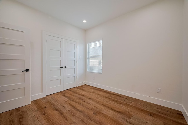 2015 Creston Dr, Houston, TX 77026 - unfurnished bedroom featuring wood finished floors, recessed lighting, and a closet