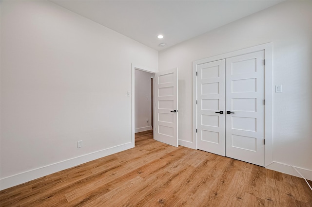 2015 Creston Dr, Houston, TX 77026 - unfurnished bedroom with light wood-style floors, a closet, and recessed lighting