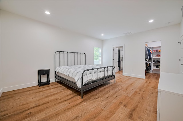 2015 Creston Dr, Houston, TX 77026 - bedroom featuring a walk in closet, light wood-style floors, recessed lighting, and a closet
