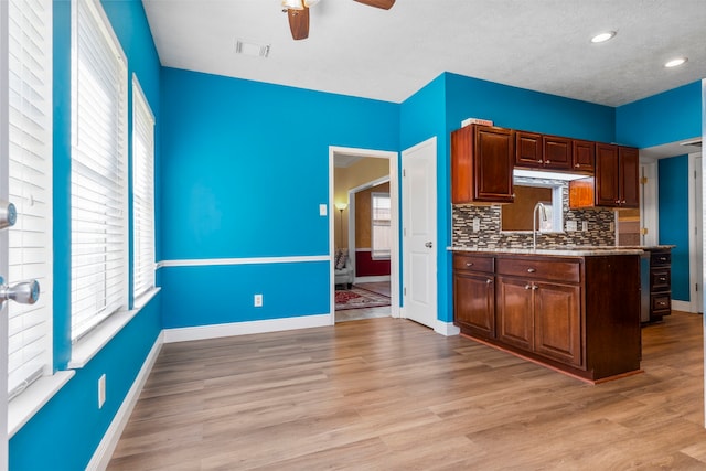 5602 Society Ln, Houston, TX 77084 - kitchen with ceiling fan, healthy amount of natural light, backsplash, light wood-style flooring, and recessed lighting