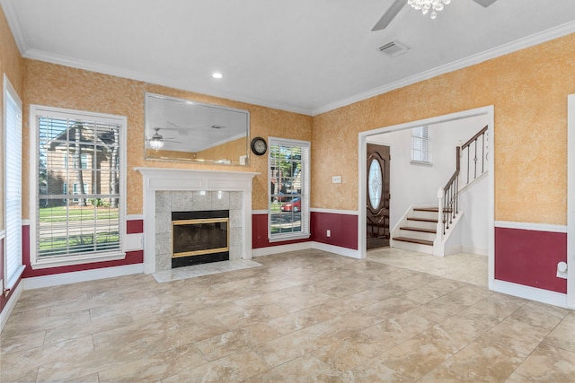 5602 Society Ln, Houston, TX 77084 - unfurnished living room with a ceiling fan, crown molding, stairs, and a tiled fireplace