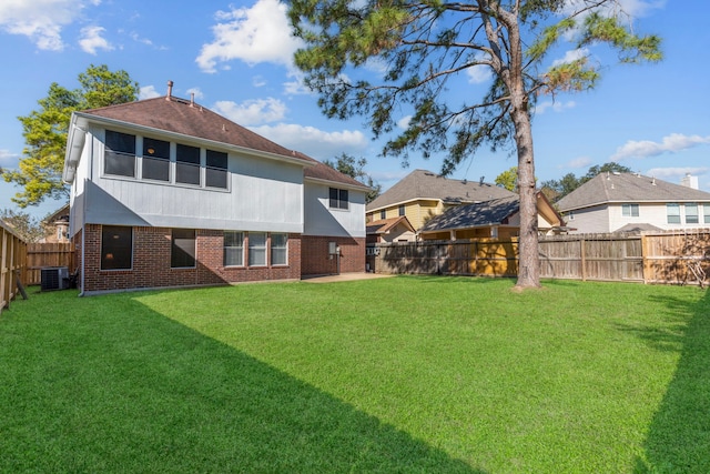 5602 Society Ln, Houston, TX 77084 - rear view of house featuring brick siding, a fenced backyard, and roof with shingles