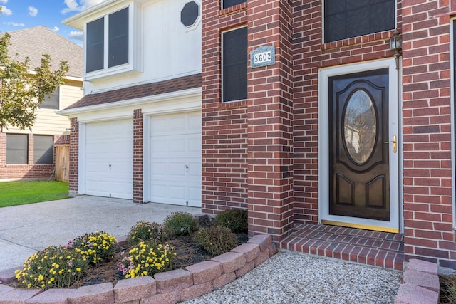 5602 Society Ln, Houston, TX 77084 - property entrance featuring concrete driveway, an attached garage, and brick siding