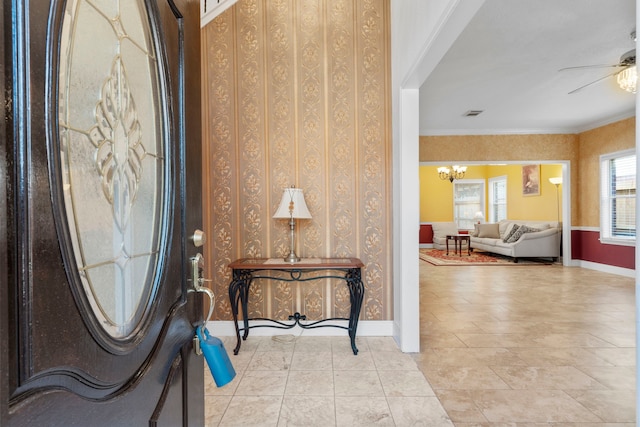 5602 Society Ln, Houston, TX 77084 - tiled entryway featuring a chandelier, a ceiling fan, and ornamental molding