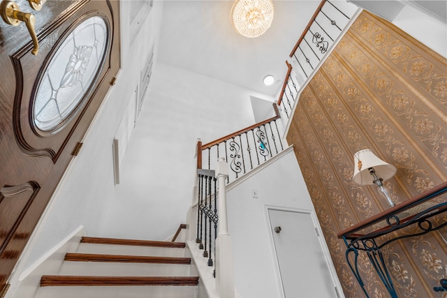 5602 Society Ln, Houston, TX 77084 - stairway featuring a high ceiling and a chandelier