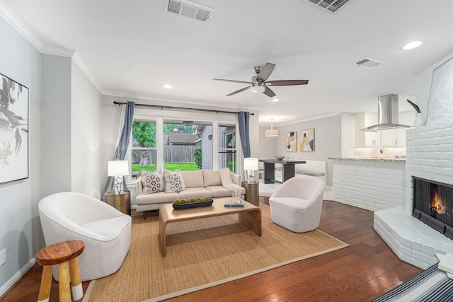 2535 Rosefield Dr, Houston, TX 77080 - living room with crown molding, wood finished floors, a ceiling fan, a fireplace, and recessed lighting