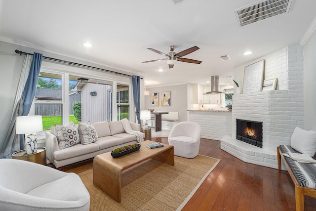 2535 Rosefield Dr, Houston, TX 77080 - living area featuring ornamental molding, ceiling fan, hardwood / wood-style floors, a fireplace, and recessed lighting