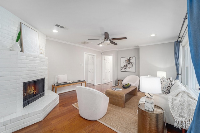 2535 Rosefield Dr, Houston, TX 77080 - living area featuring wood finished floors, ceiling fan, recessed lighting, a brick fireplace, and crown molding
