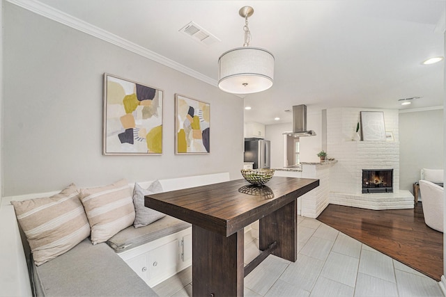 2535 Rosefield Dr, Houston, TX 77080 - dining space with crown molding, a fireplace, and recessed lighting