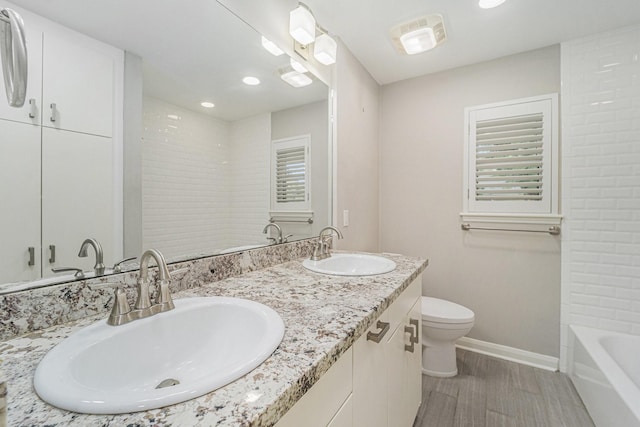 2535 Rosefield Dr, Houston, TX 77080 - full bathroom with wood finished floors, double vanity, and recessed lighting