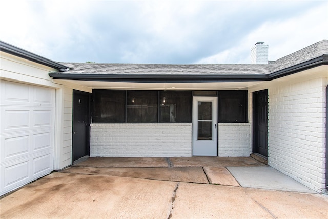 11523 Bandlon Dr, Houston, TX 77072 - doorway to property with brick siding, roof with shingles, an attached garage, and a chimney