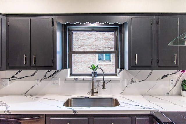 11523 Bandlon Dr, Houston, TX 77072 - kitchen with dark cabinetry, dishwasher, light stone countertops, and stovetop